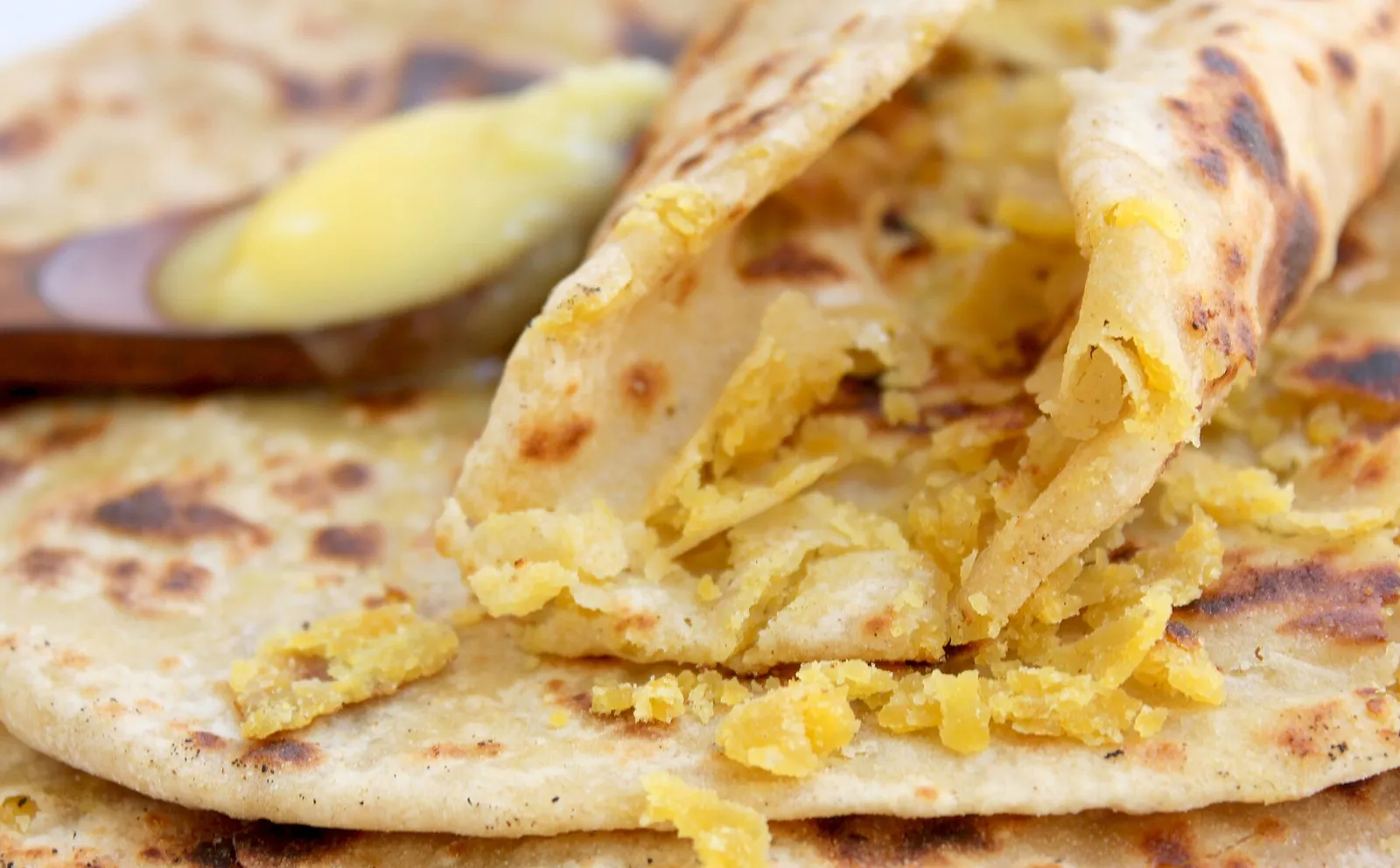 Puran poli from Maharashtra cut open to show the chana dal filling, with ghee, a close cousin of Nagercoil boli