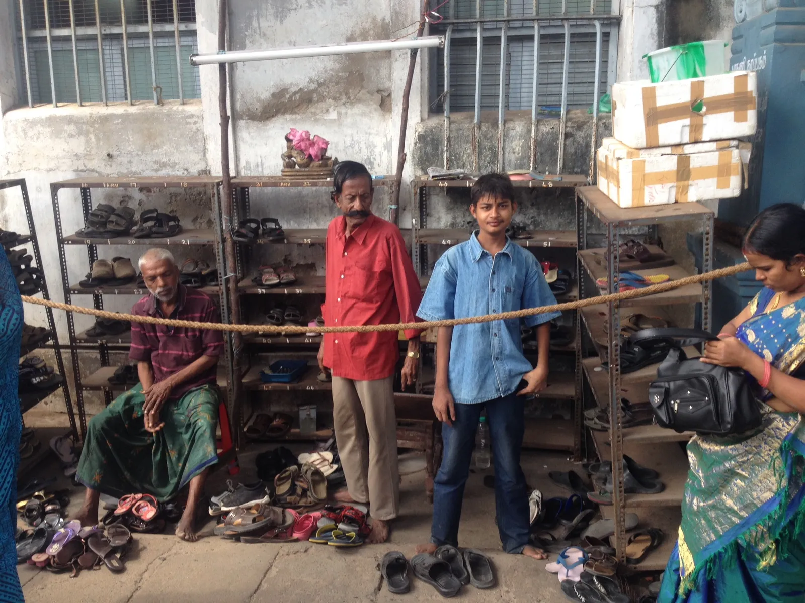 Attended footwear stand outside a Tamil Nadu temple, where visitors leave shoes before entering