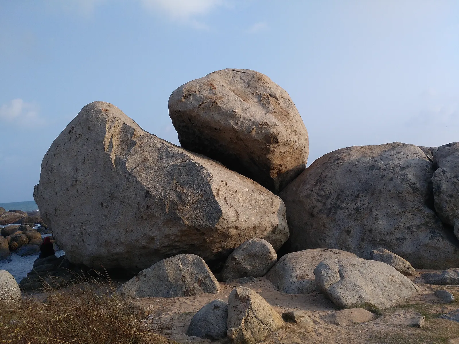 Rocky shoreline of Kanyakumari with waves breaking near the sunrise point