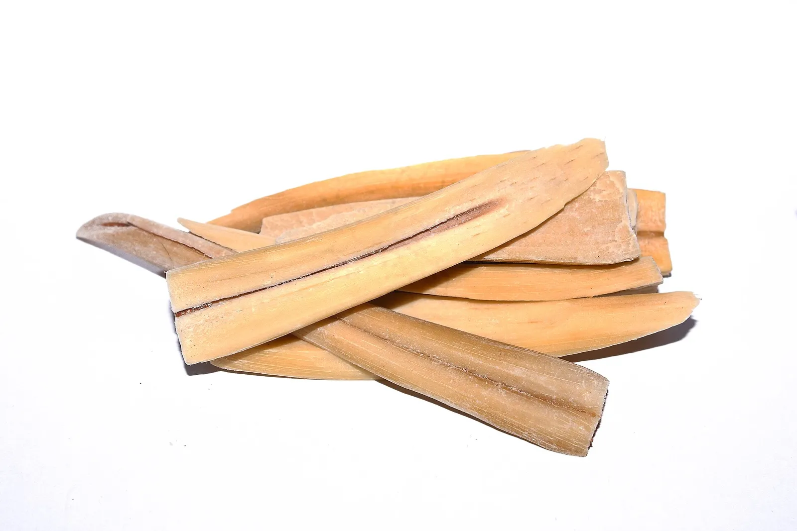 Boiled palmyra sprout pieces split lengthwise, showing the pale fibrous flesh of panang kizhangu