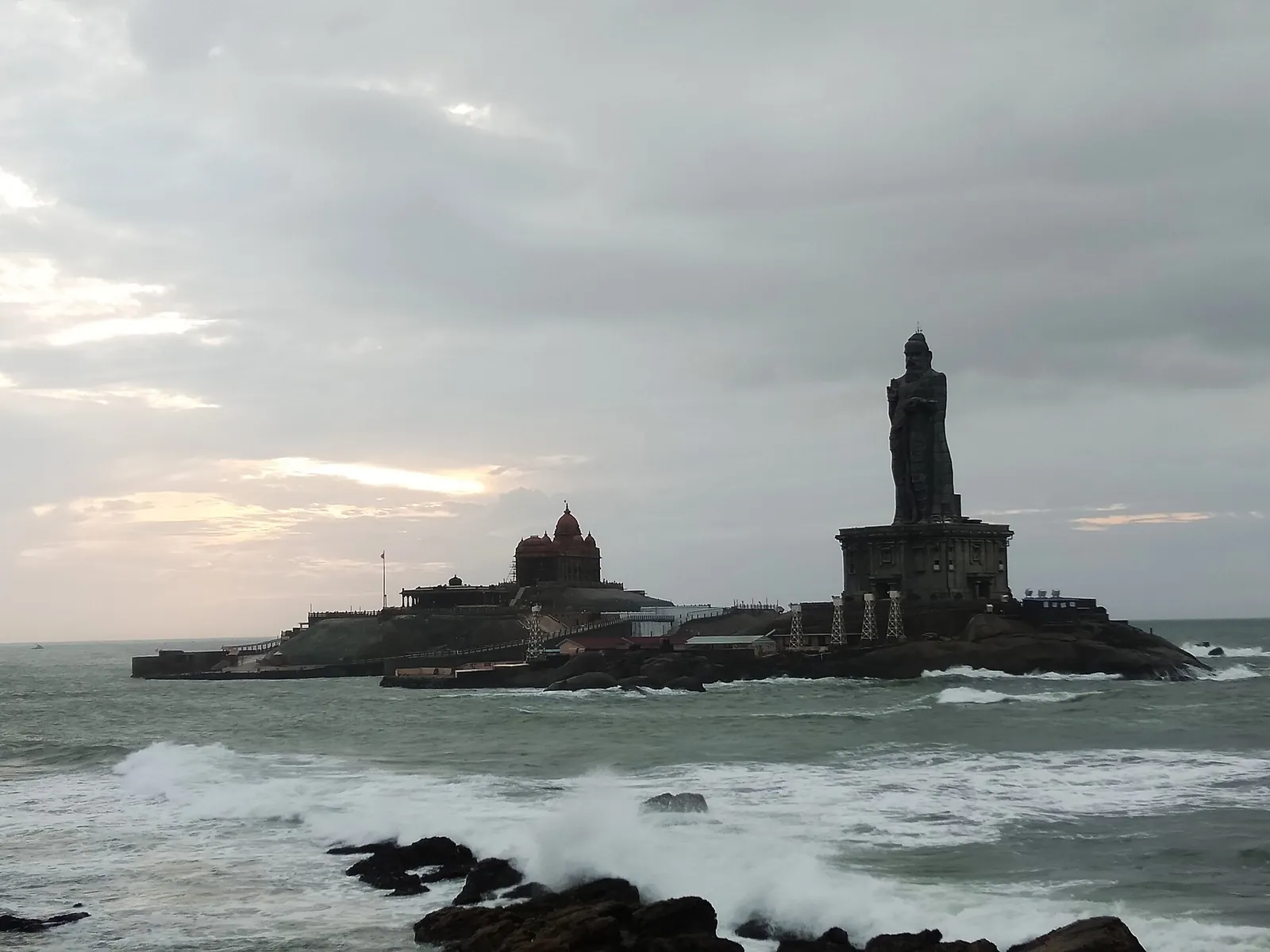 Thiruvalluvar Statue on its islet seen from the Kanyakumari ferry, reached by glass bridge from Vivekananda Rock
